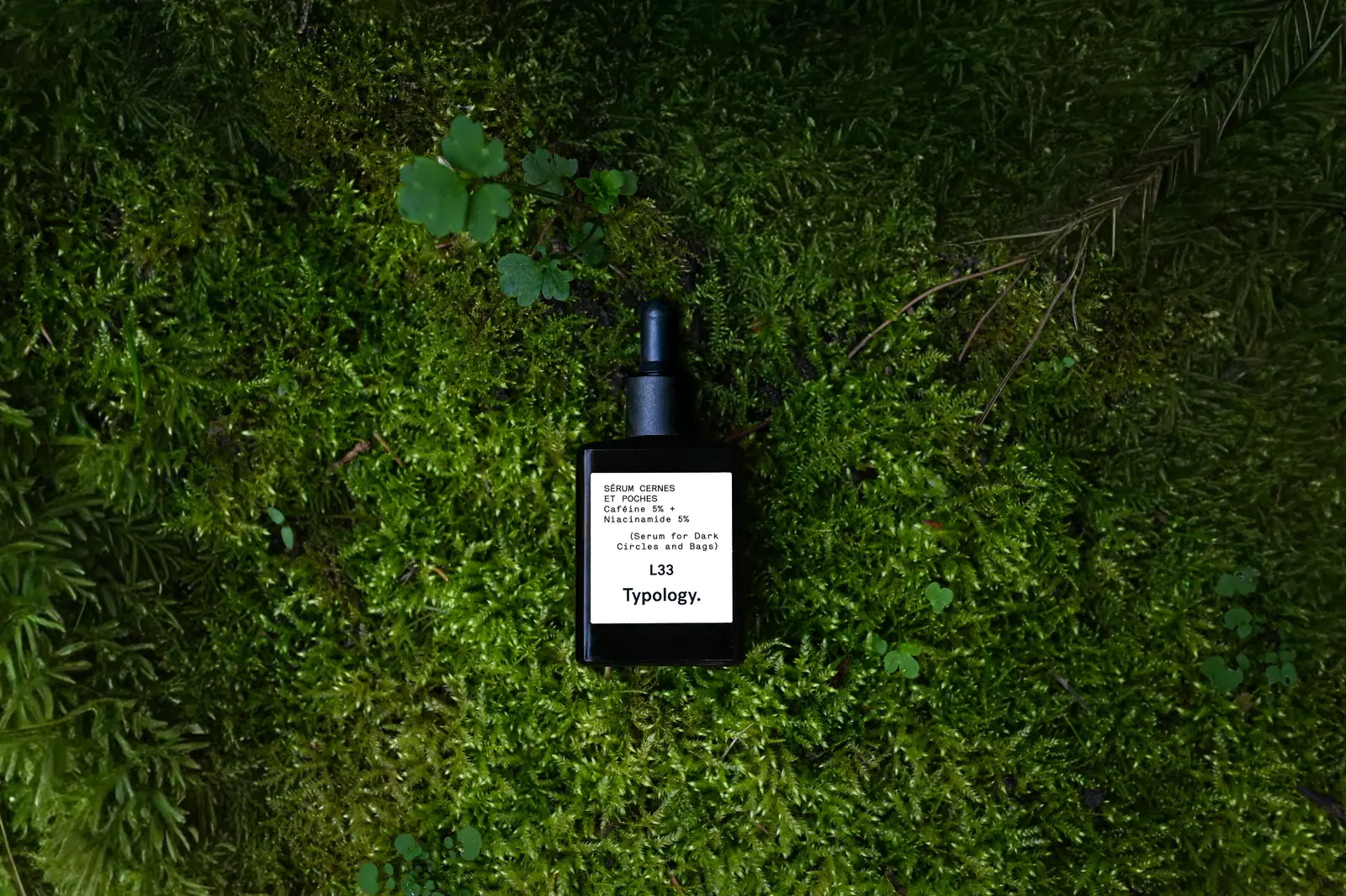 Typology serum resting in thick green moss